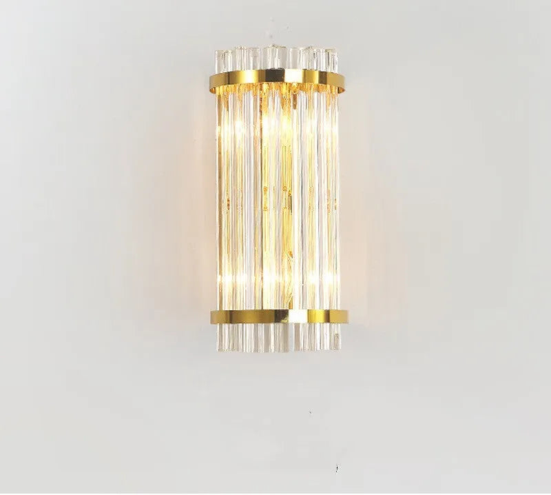 Modern crystal petal-shaped wall lamp in titanium gold finish mounted on a light-coloured wall.
