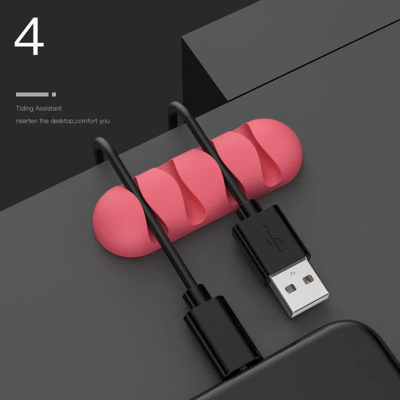 Smart cable holder with TPR flexible clips in black holding USB earphone and network cables on a desk