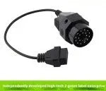BMW 20-pin male to OBD2 16-pin female diagnostic adapter cable on a workshop bench