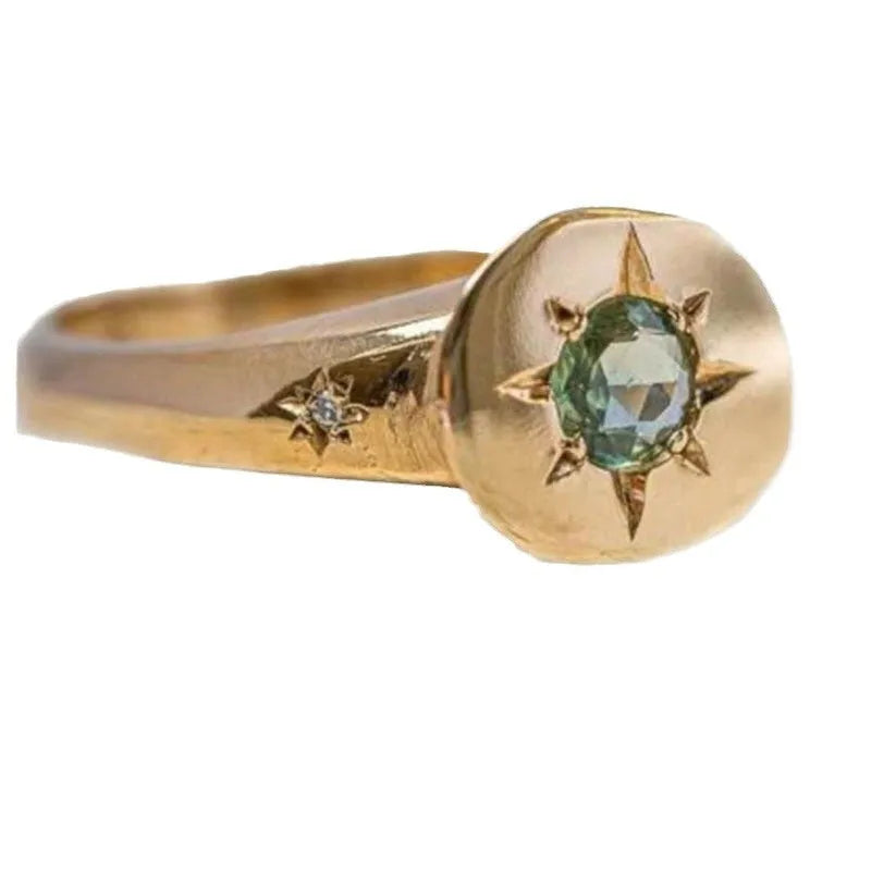 Golden oval ring with a star design and adjustable opening.