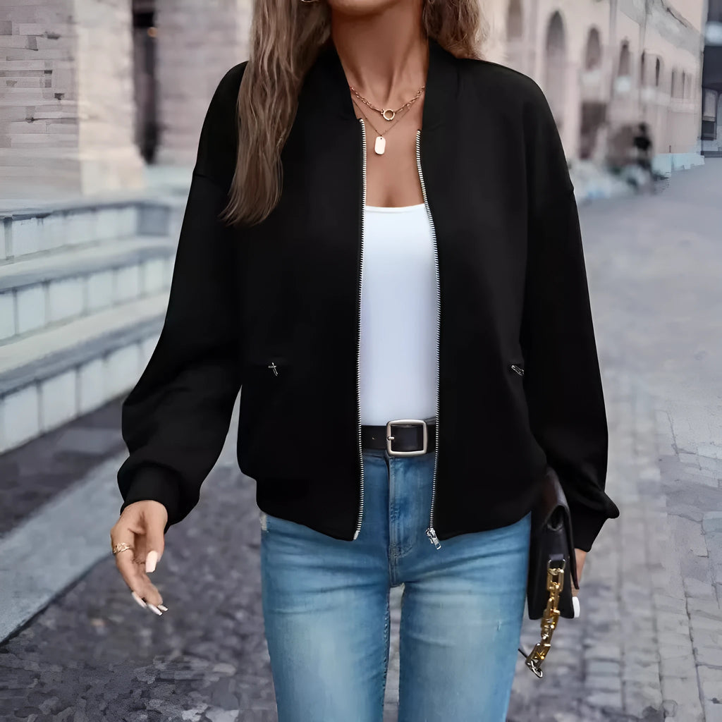 Black women's casual zip-up jacket with long sleeves and faux pockets on a hanger.