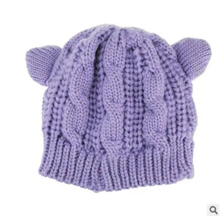 Hand made 3D knitted cat ear beanie in wool, shown in multiple colour options including red, black and beige.