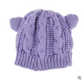Hand made 3D knitted cat ear beanie in wool, shown in multiple colour options including red, black and beige.