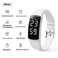 Vibration alarm smart watch with coloured silicone strap and LED display on wrist