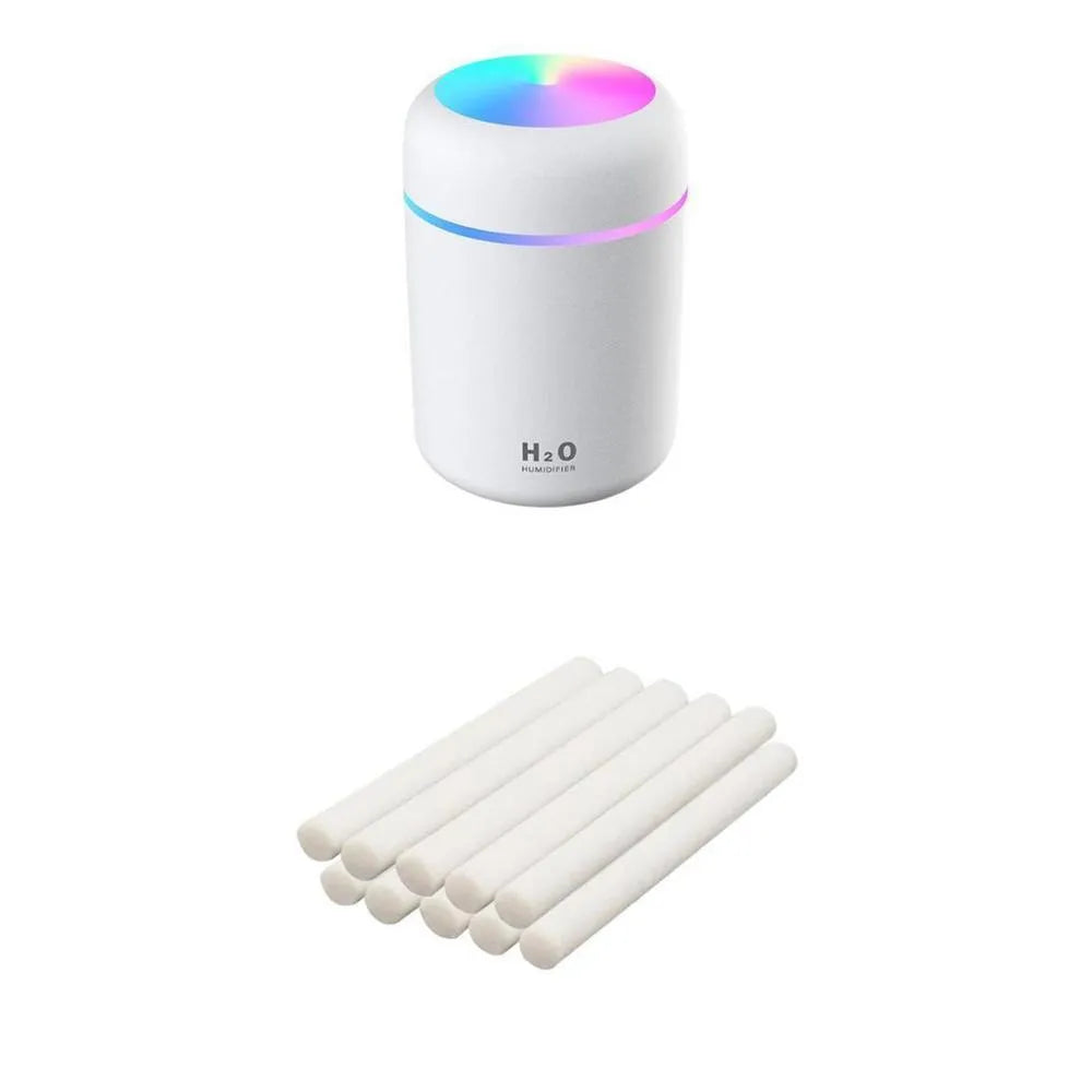 Pink USB desktop humidifier with colourful LED lights and 300ml water tank on wooden desk