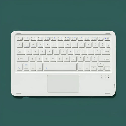 Pink Bluetooth touch keyboard and rechargeable wireless mouse on a desk next to a tablet.