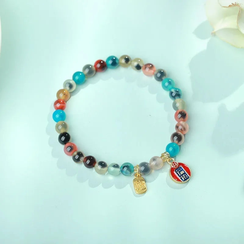 Women's agate bracelet with copper coin snake chain and coloured glaze detailing in geometric bead design