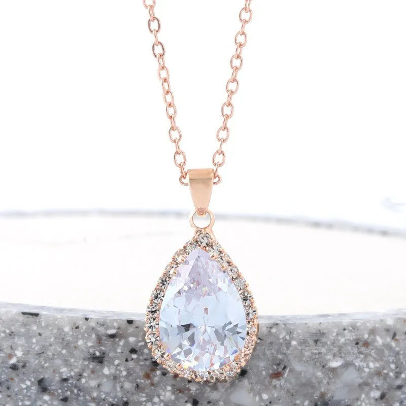 Rose gold geometric drop necklace with rhinestone details in pink colour option