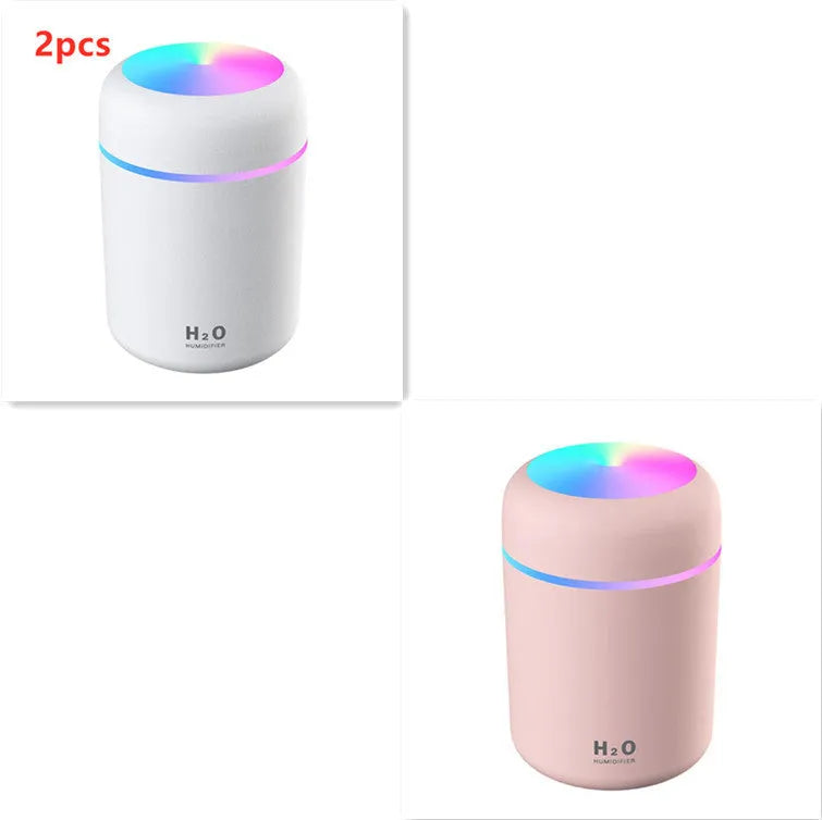 Pink USB desktop humidifier with colourful LED lights and 300ml water tank on wooden desk