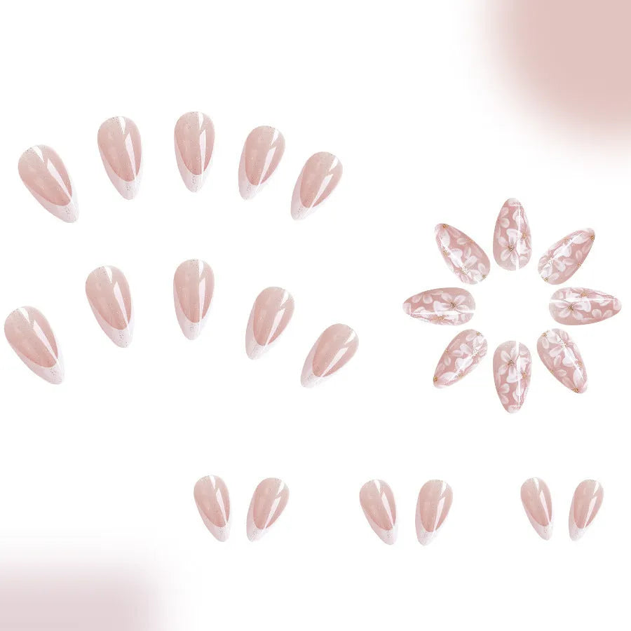 Short almond-shaped false nails with glossy French tip and glitter flower decoration, colour C625.