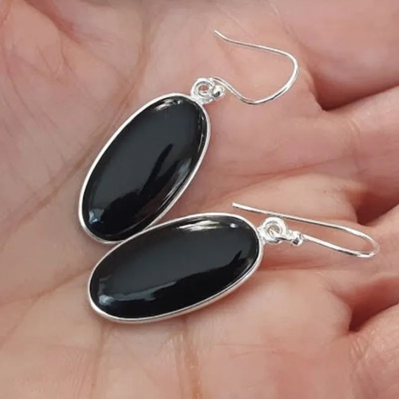 Black agate oval pendant earrings with geometric silver-toned frames and drop earring design