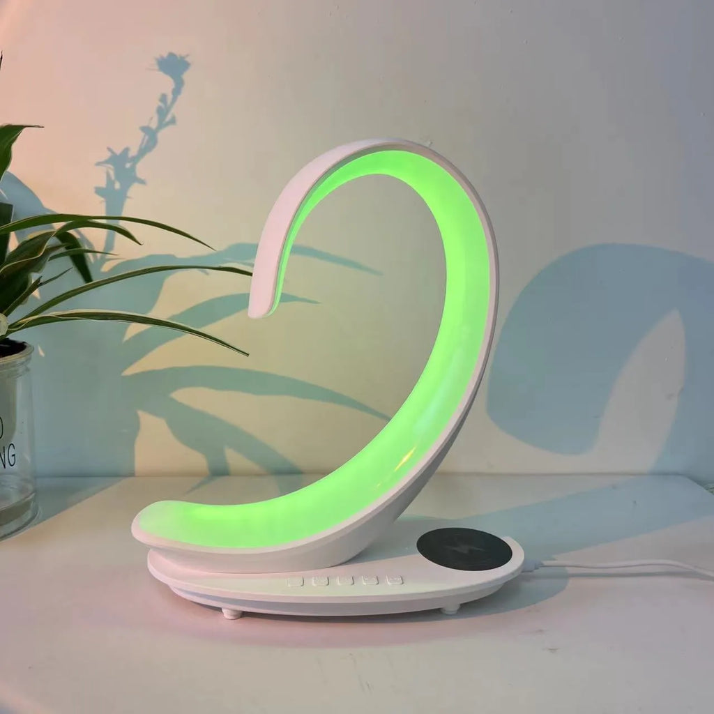 White swan-shaped desktop lamp with wireless charging pad, Bluetooth speaker and colourful atmospheric lighting effects