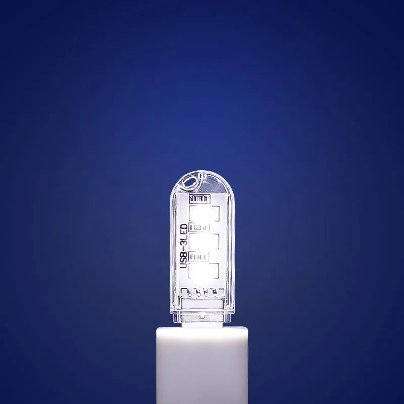 Small white cylindrical USB LED night light showing white and warm light colour options.