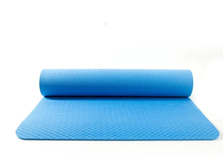 Pure colour EVA yoga brick, thick non-slip mat, and cotton tension band on a floor, in blue, purple, pink, red, black, gray