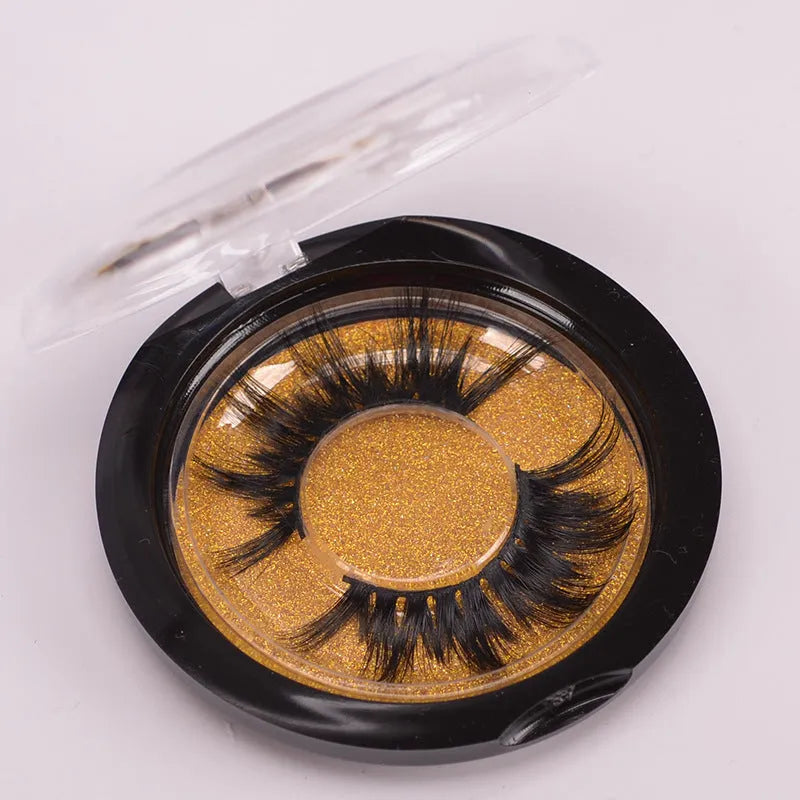 5D mink hair false eyelashes set with brush and storage cap on pink background.