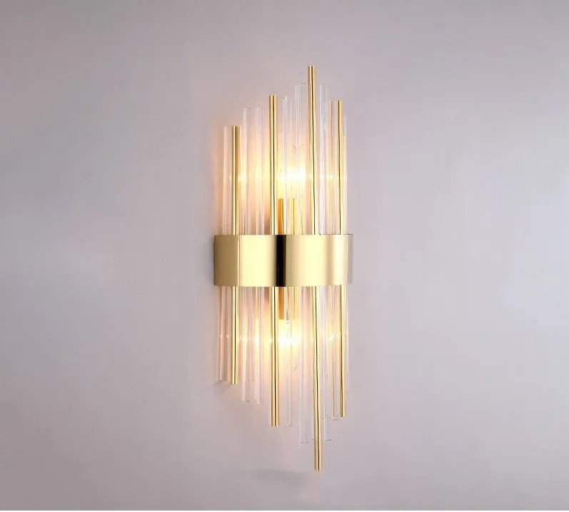 Modern crystal petal-shaped wall lamp in titanium gold finish mounted on a light-coloured wall.