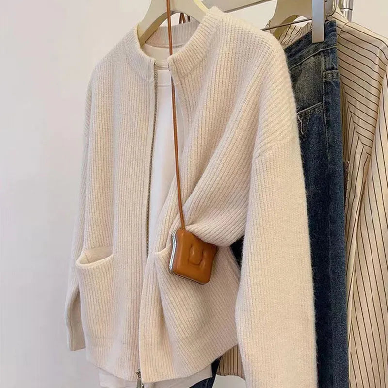 Beige women's long sleeve soft glutinous sweater coat cardigan laid flat.