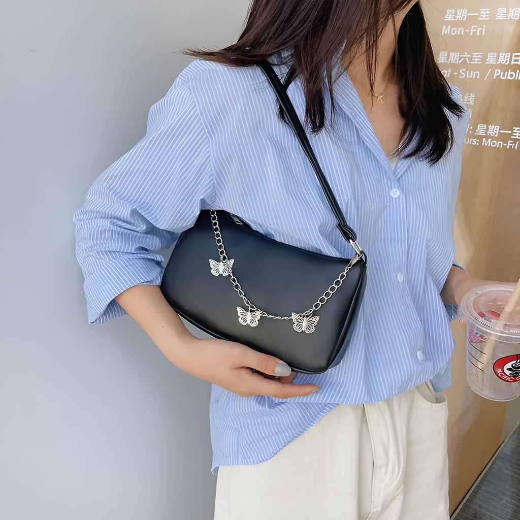 Retro women's chain-strap crossbody bag with butterfly charm in light blue PU leather