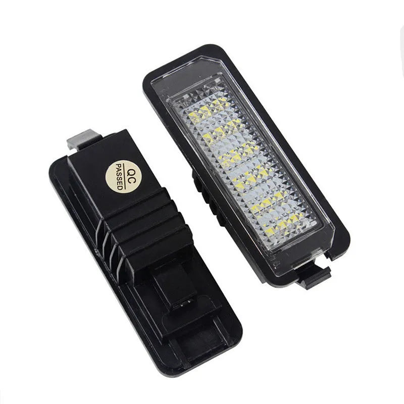 Two Volkswagen LED license plate light units with multiple white SMD LEDs visible.