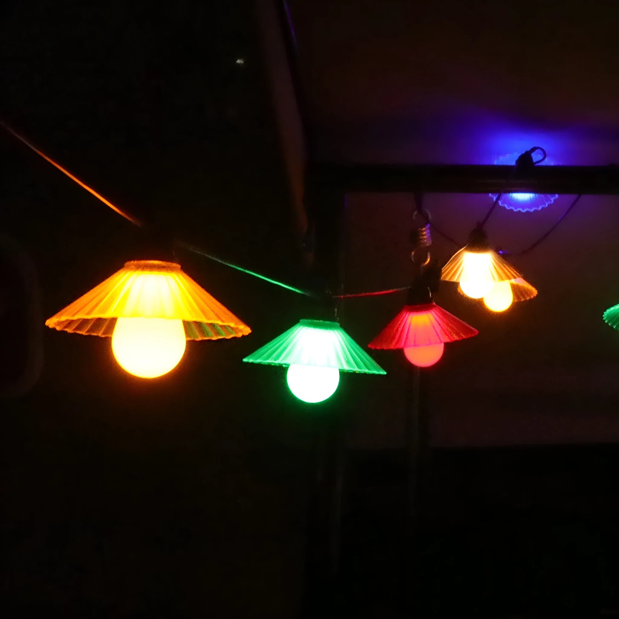 Outdoor LED string lights with flower-shaped bulbs showing warm white and coloured lighting options