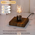 Creative iron art night lamp with a suspended bulb on a black wood grain base.