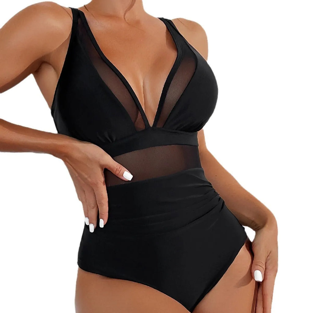 Black women's halter neck one-piece swimsuit with mesh detail and high-cut briefs.