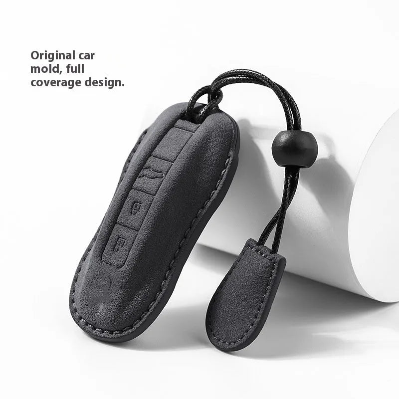 Suede car key cover in cement grey, dark green, light grey, and orange colour options.