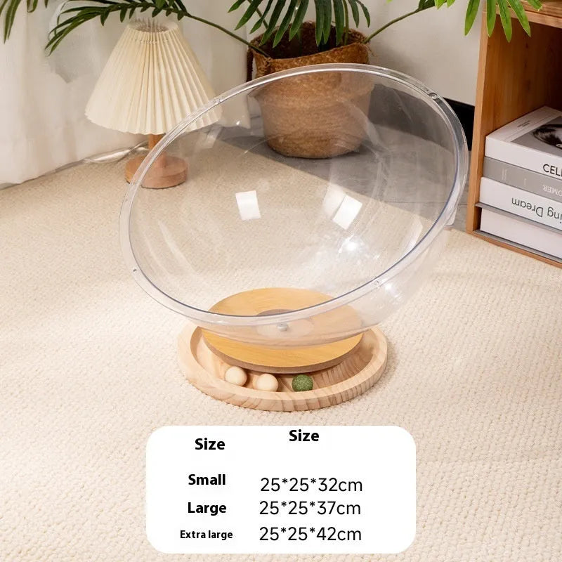 Transparent acrylic space capsule-shaped cat bed or enclosure on a turntable base.