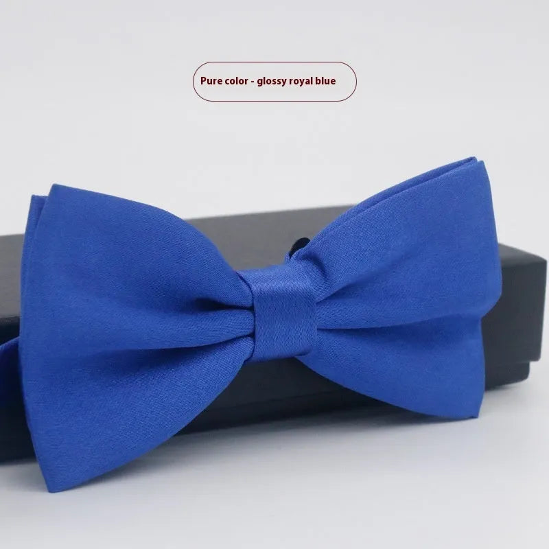 Solid colour flat head bow tie for formal wear in multiple colours including black, red, and blue.