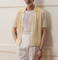 Yellow men's casual polo shirt with hollow-out detailing and an asymmetric short sleeve hem.