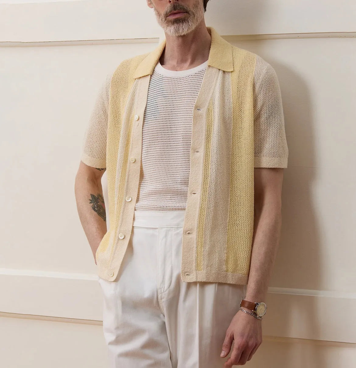 Yellow men's casual polo shirt with hollow-out detailing and an asymmetric short sleeve hem.