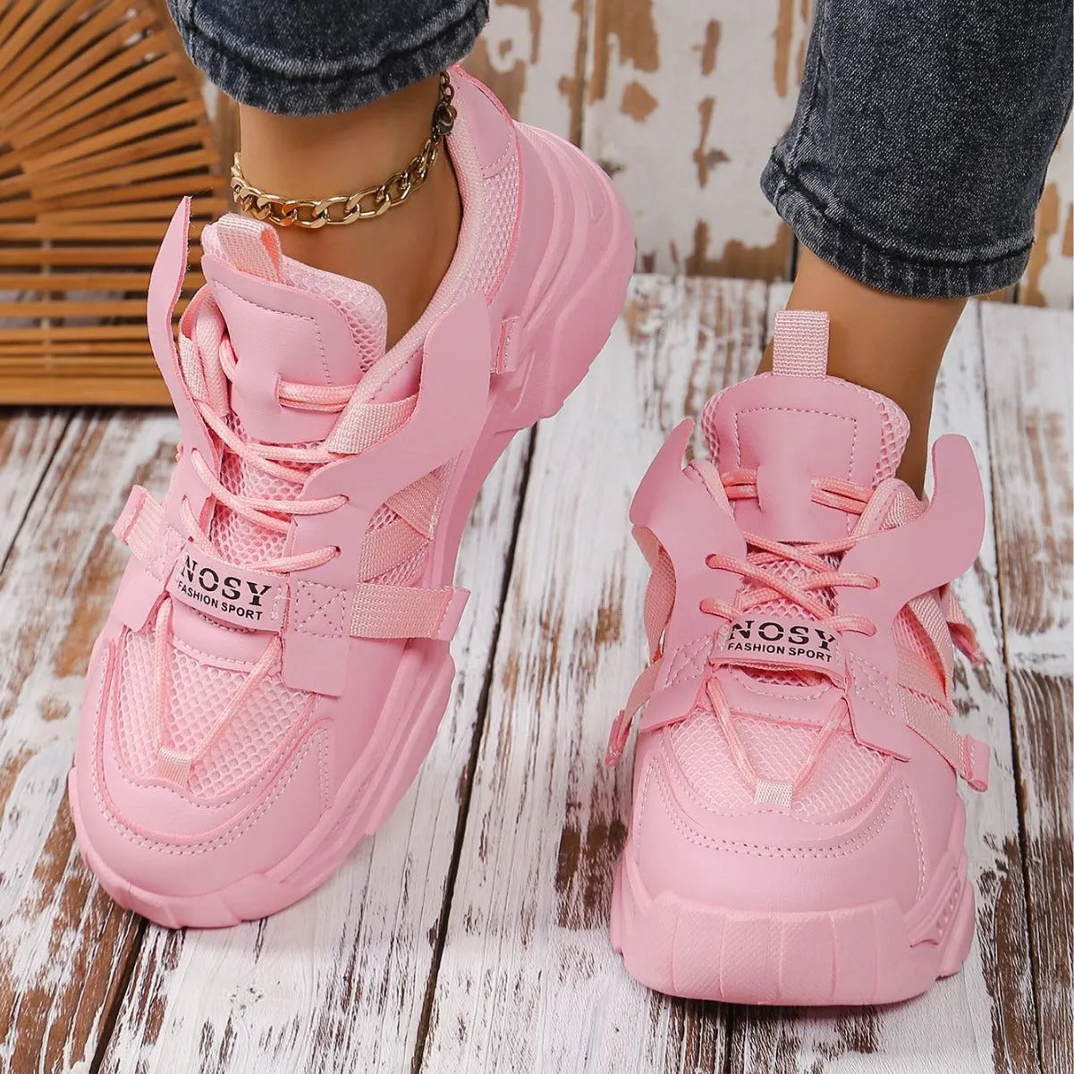 Women's platform mesh dad sports trainer in animal pattern, showing lace-up front and height-increasing sole.