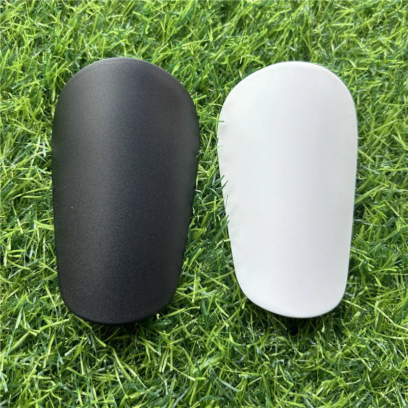 Extra small mini football shin guards measuring 8x5cm in black and white colours
