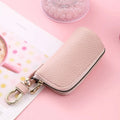 Men's fashion simple black PU leather zippered key ring case on a grey background.