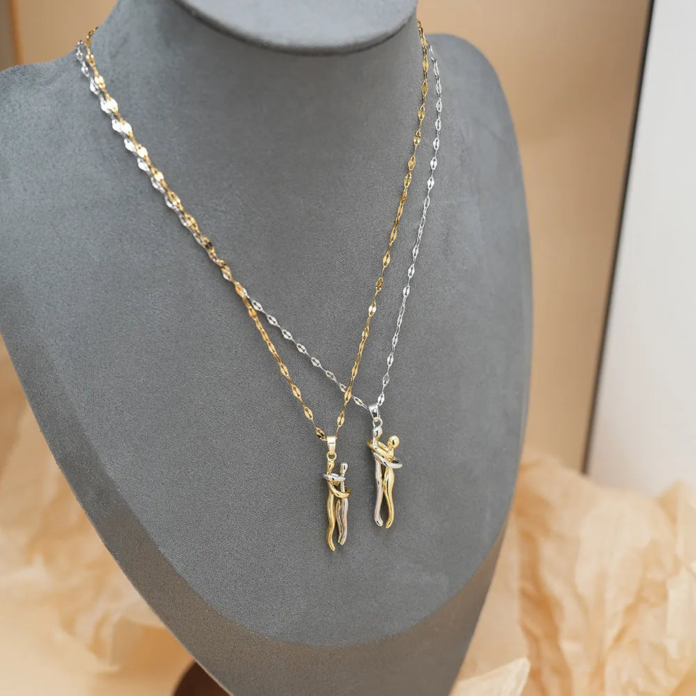 Couple hugging bronze pendant necklace on unisex stainless steel chain with gold lip chain finish, casual style