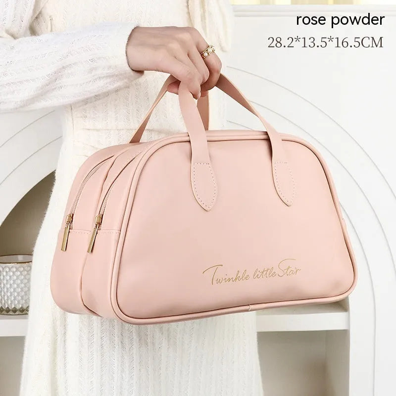 Large leather travel toiletry bag open to show dry and wet separation compartments.
