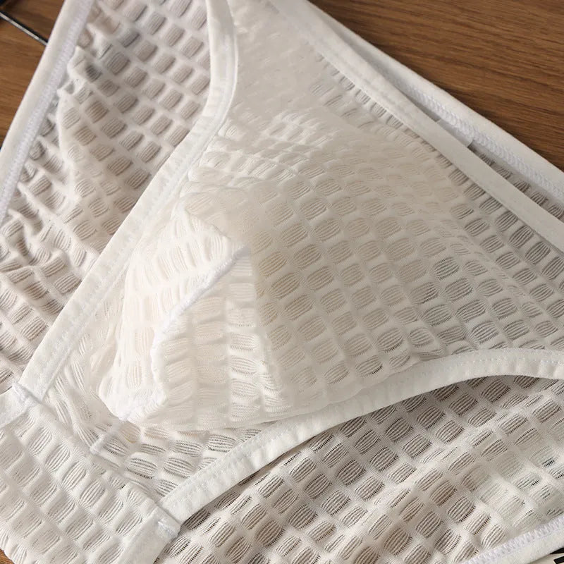 Men's low waist transparent lace underwear in a choice of colours on a size chart.
