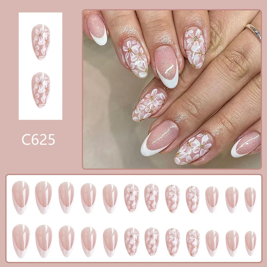 Short almond-shaped false nails with glossy French tip and glitter flower decoration, colour C625.