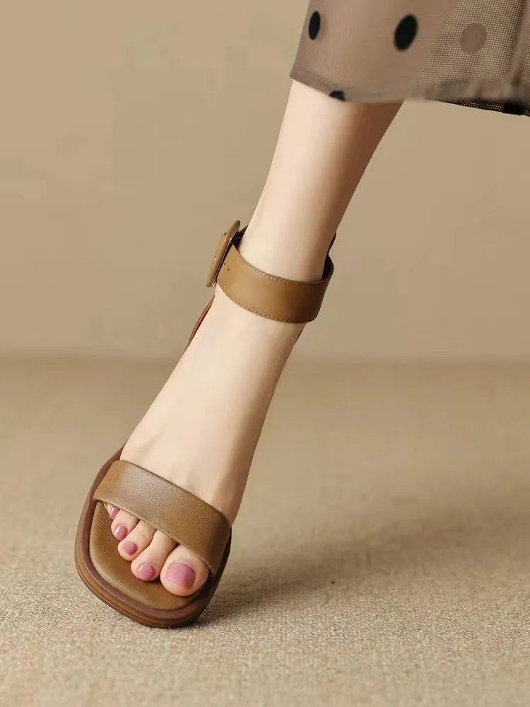 Women's white retro ankle-strap platform high heels with a round toe on a neutral background.