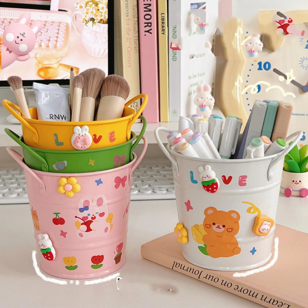 Round metal desktop pen holder showing colour options including green, pink, red, white and yellow