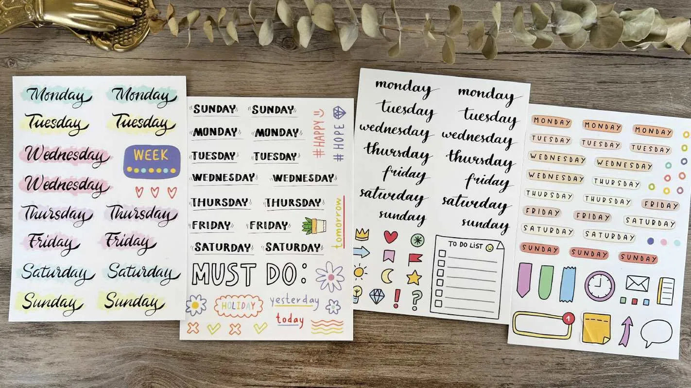 Set of printed cute-style stickers showing English letters A, B, C, D, E, numbers, symbols, and weekly words on a sheet.