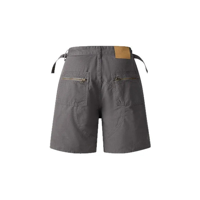 Retro loose-fit washed cotton workwear shorts for men and women in camouflage colour with a zipper fly.