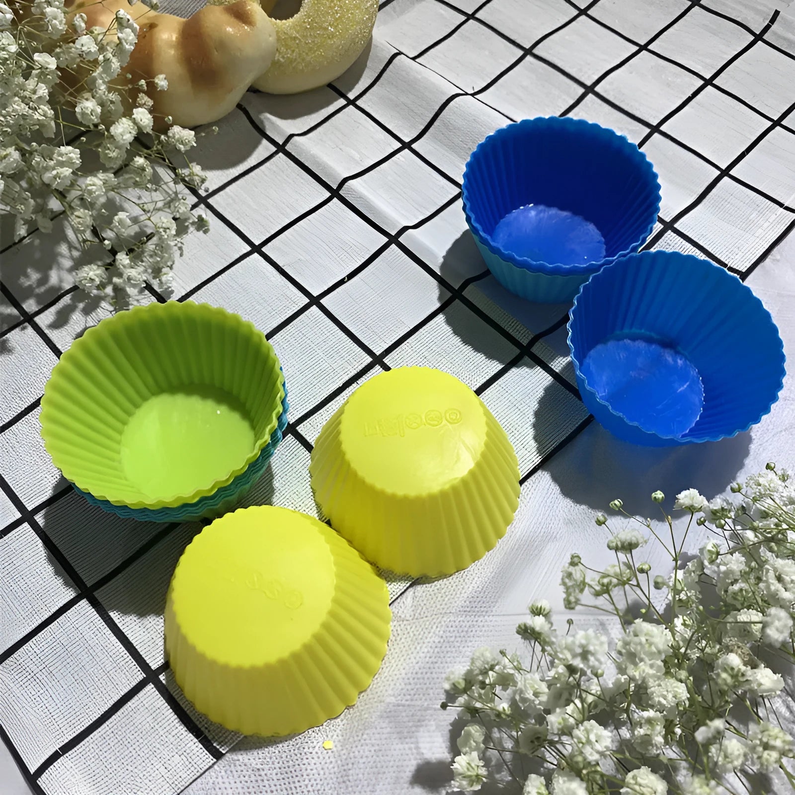 12 nonstick reusable silicone cupcake liners in six colours arranged for baking