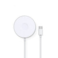 Mini magnetic three-in-one wireless charger in silver with Type-C port on desk next to devices