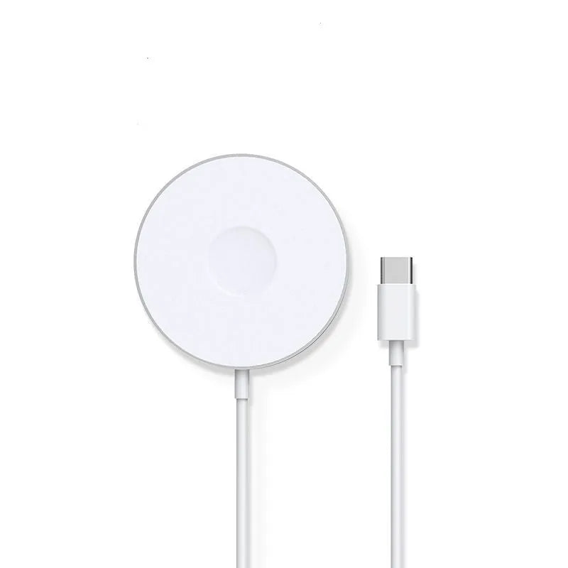 Mini magnetic three-in-one wireless charger in silver with Type-C port on desk next to devices