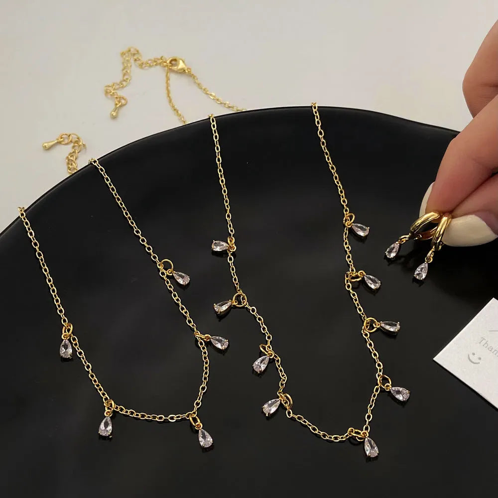 Zircon necklace, earrings, and anklet set with geometric meteor shower design on a regular chain.