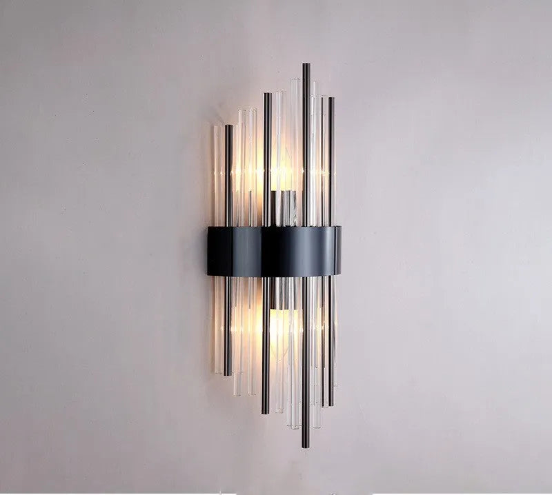 Modern crystal petal-shaped wall lamp in titanium gold finish mounted on a light-coloured wall.