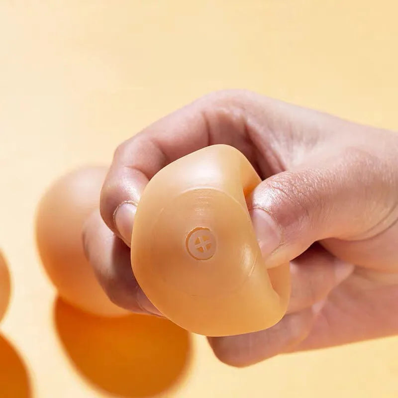 Chicken-flavoured simulation egg dog toy with textured surface for dental cleaning
