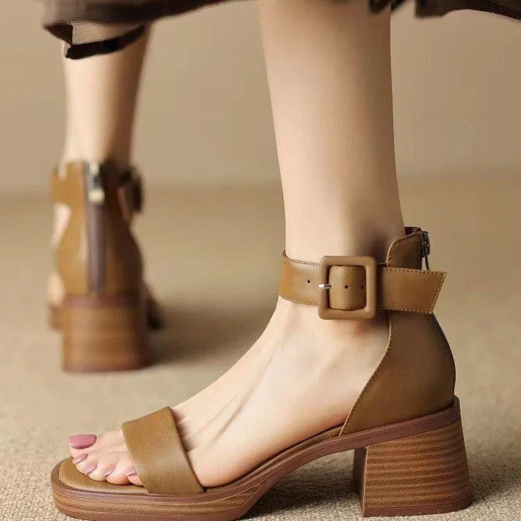 Women's white retro ankle-strap platform high heels with a round toe on a neutral background.