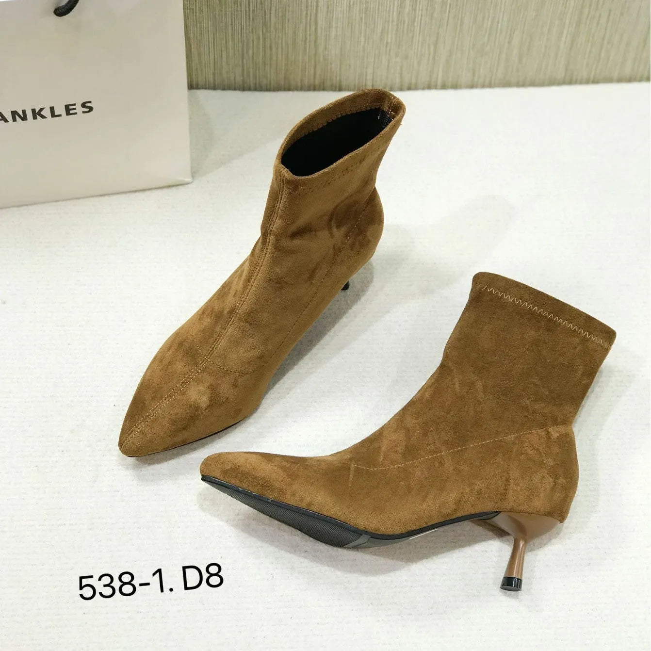 Black pointed toe women's ankle boots with stiletto heel and mid-calf height